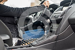 Woman driving car, hands on steering wheel closeup