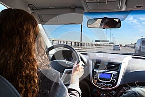 Woman driving car on highway, inside view