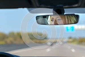 Woman driving a car on a motorway