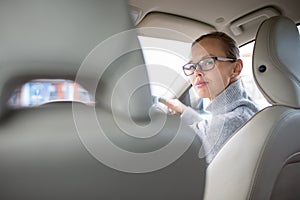 Woman driving a car - parking, going in reverse