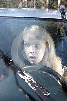 Woman driving a car in the rain