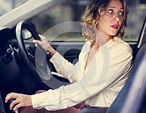 Woman driving a car in reverse photo