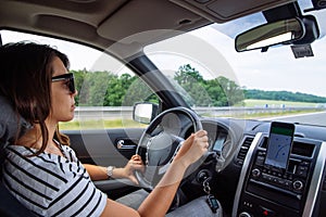 woman driving car by speedway summer time