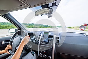 woman driving car by speedway summer time