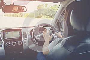 Woman driving car, steering wheel of a car