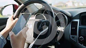 Woman driving car texting message on mobile phone in motion, don't text and drive