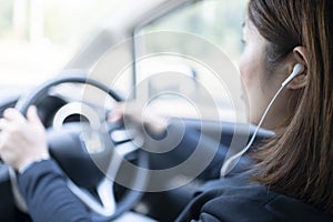 Woman driving a car and using mobile phone for calling