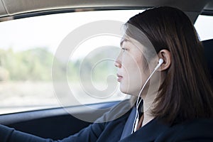 Woman driving a car and using mobile phone for calling