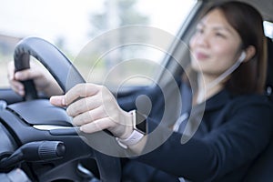 Woman driving a car and using mobile phone for calling