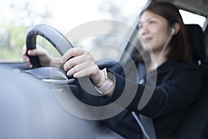 Woman driving a car and using mobile phone for calling