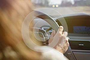 Woman driving a car, view from behind