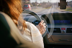 Woman driving a car, view from behind