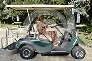 Woman driving golf carts photo