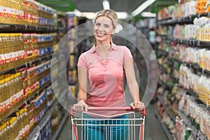 Woman Driving Shopping Cart While Grocery in Supermarket