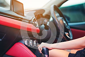 Woman driving, using a manual transmission stick shift. close up of woman shifting gears on gearbox and driving car selective