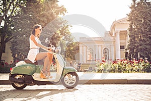 Woman driving vintage scooter