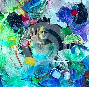 Woman drowning in ocean water under plastic recipients pile, environment concept