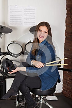 Woman drummer practicing at home