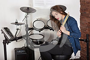 Woman drummer practicing at home