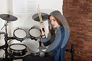 Woman drummer practicing at home