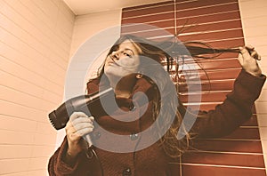 Woman drying her hair