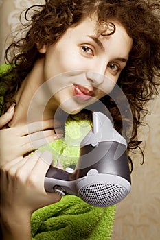 Woman drying her hair with hairdryer