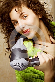 Woman drying her hair with hairdryer