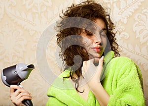 Woman drying her hair with hairdryer