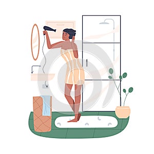 Woman drying wet hair with blowing hairdryer in front of mirror in bathroom. Happy female in towel, using dryer after