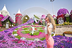 Woman in Dubai Garden portrait. Sunny day beautiful flowers backgrounds