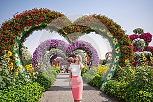 Woman in Dubai Garden portrait. Sunny day beautiful flowers backgrounds