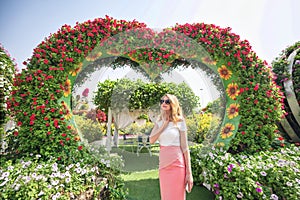 Woman in Dubai Garden portrait. Sunny day beautiful flowers backgrounds