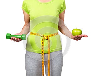 Woman with dumbbells and apple