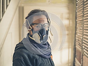 Woman with dust mask and goggles in hallway