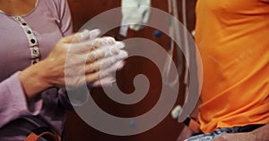 Woman dusting her hand with chalk power at bouldering gym 4k