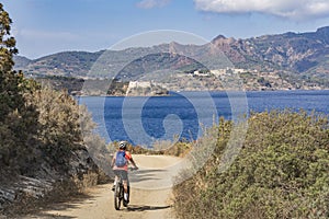 Woman with e bike on Elba Island, Italy