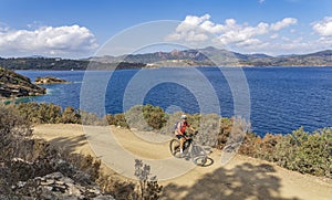 Woman with e bike on Elba Island, Italy