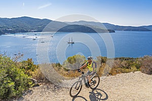 Woman with e bike on Elba Island, Italy