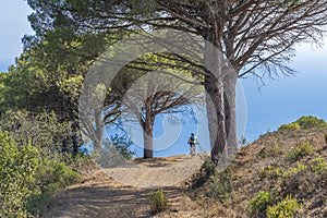 Woman with e bike on Elba Island, Italy