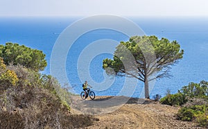 Woman with e bike on Elba Island, Italy