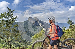 Woman with e bike on Elba Island, Italy