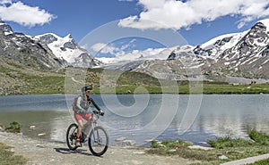 Woman on e mountain bike at Stelli lake above Zermatt, Switzerland