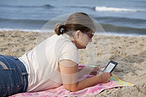 Woman with E-Reader at Beach