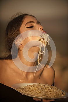 Woman eagerly eats spaghetti. Diet and healthy organic food, italy. Italian macaroni or spaghetti for dinner, cook. Chef