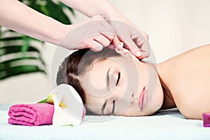 Woman on ear massage in salon