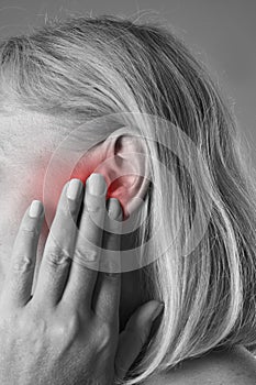 Woman with earache, ear pain closeup