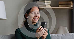 Woman in earphones listen audio messages on smartphone