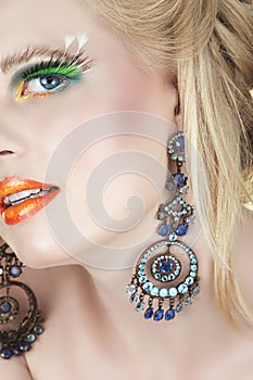 Woman with earrings and false lashes