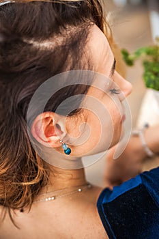 Woman and earrings made of natural stones. The mysticism of amulets. Esoterics in handmade jewelry close-up and copy space. Jewelr