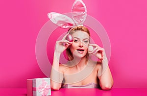 Woman with Easter eggs. Cute girl wearing bunny ears on Easter day.